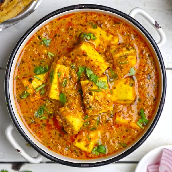 Himalayan Grill's paneer butter masala, a rich Indian curry with paneer cubes and cilantro.